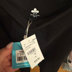 Plain black skirt. Brand is three bows.